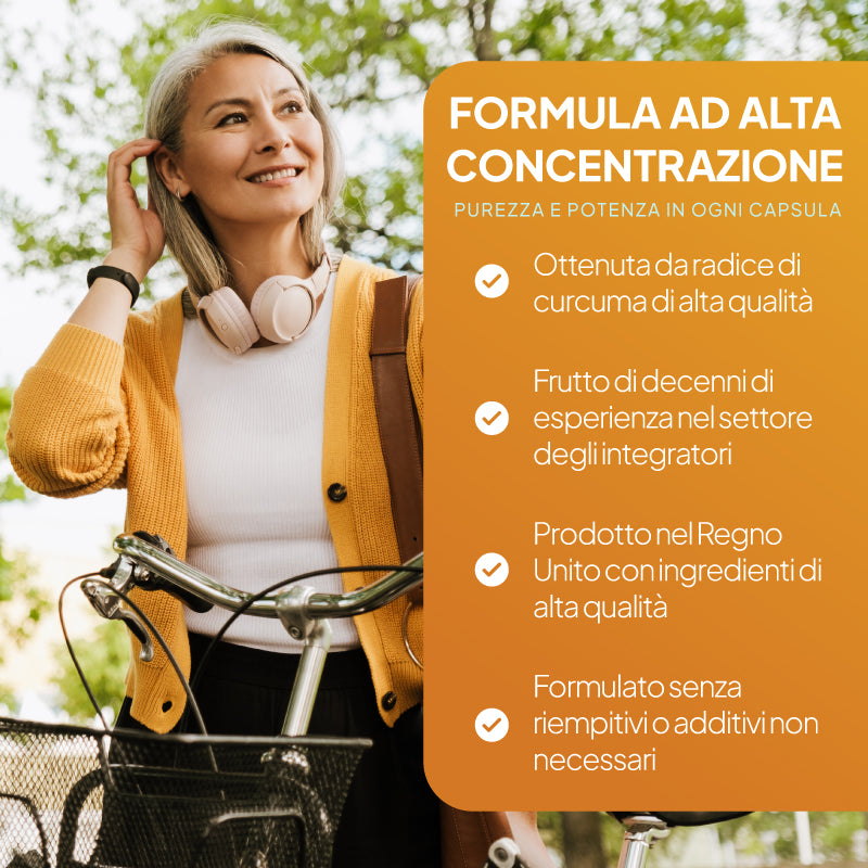 Una donna con un cardigan giallo e un top bianco è in piedi all’aperto vicino a una bicicletta; alla sua destra si vede un grande cartellone arancione con una scritta in italiano che pubblicizza una formula ad alta concentrazione.